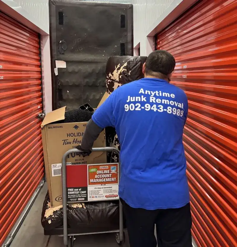 Anytime Junk Removal crew member clearing a storage unit in Halifax